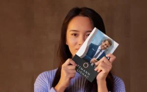 Woman holding an Ottmann-Polignac branded brochure with professional business design