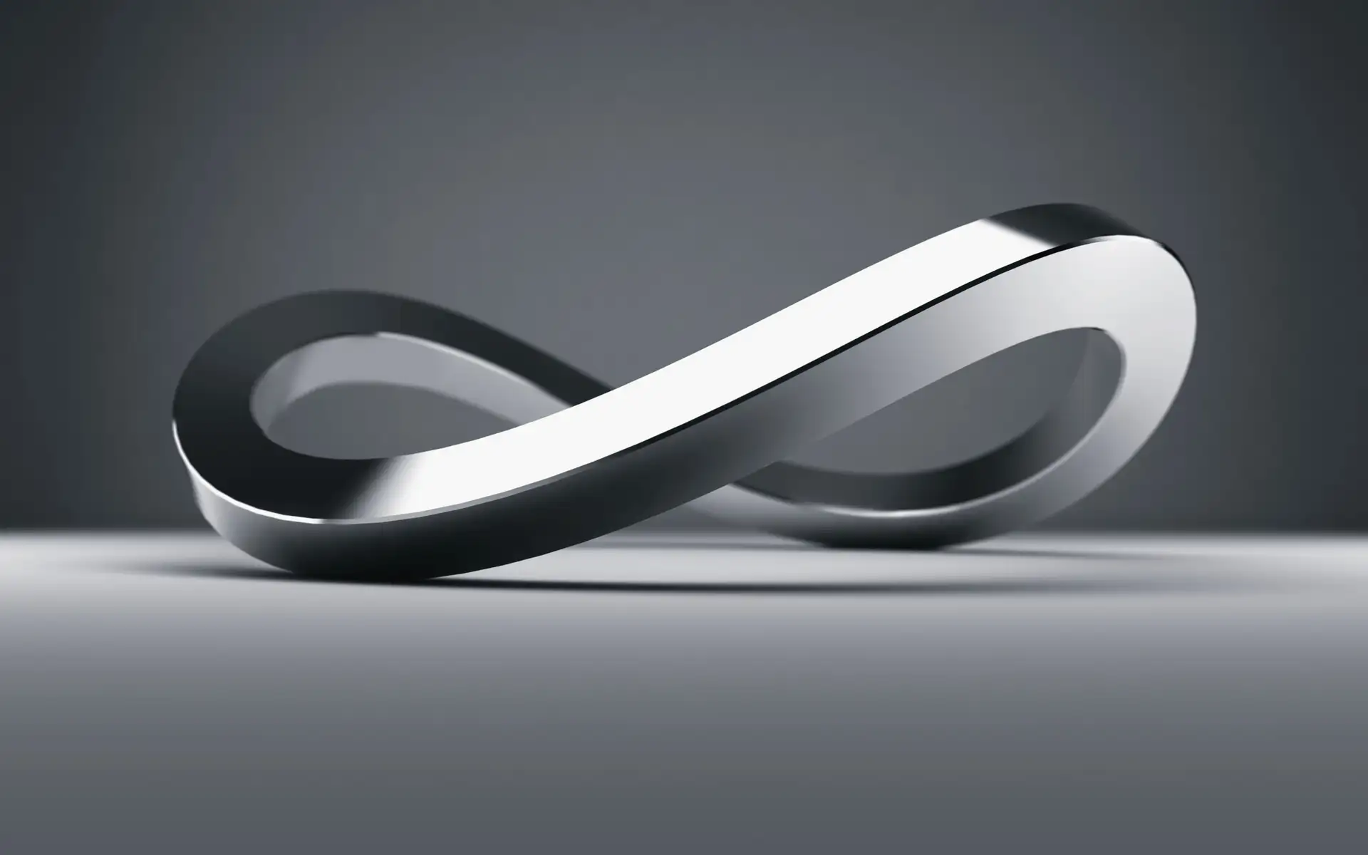 Metallic infinity symbol on grey background, representing limitless branding and continuity.