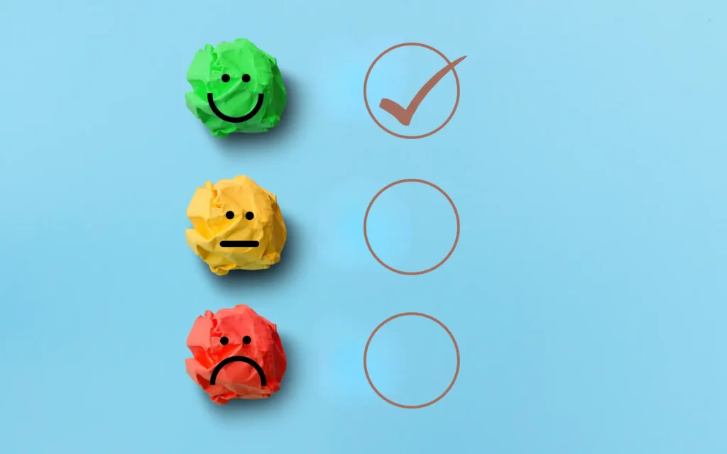 Smiling, neutral and sad faces on crumpled paper showing online reputation improvement