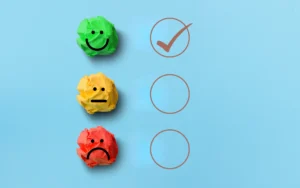 Smiling, neutral and sad faces on crumpled paper showing online reputation improvement