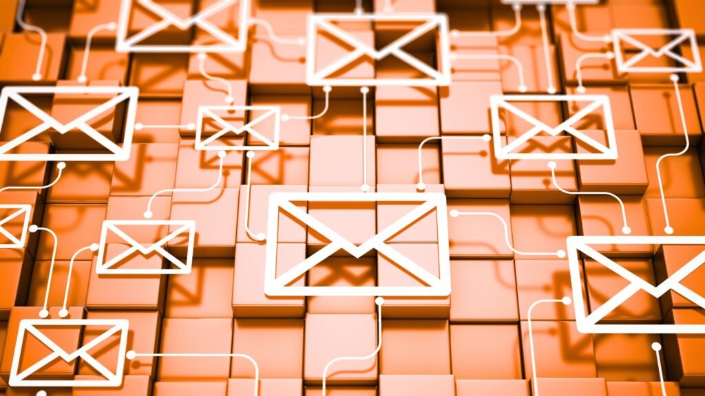 Interconnected white email icons on an orange grid background, symbolising newsletter setup and automation.