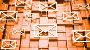 Interconnected white email icons on an orange grid background, symbolising newsletter setup and automation.