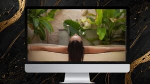 Computer monitor with a woman relaxing in a spa bath surrounded by greenery, symbolising luxury newsletter graphic design.